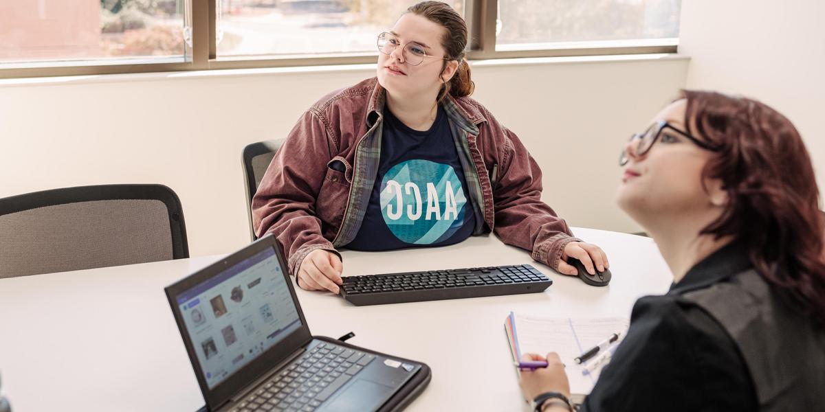 Students looking at screen while studying together.